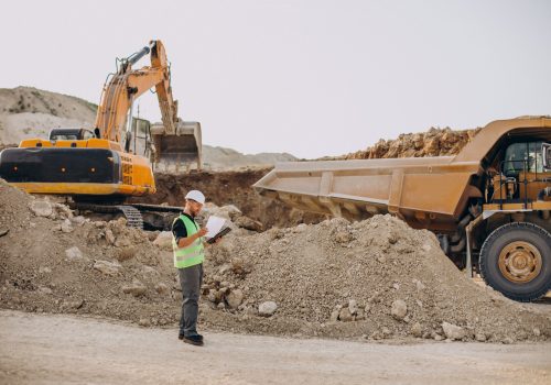 Male worker with bulldozer in sand quarry